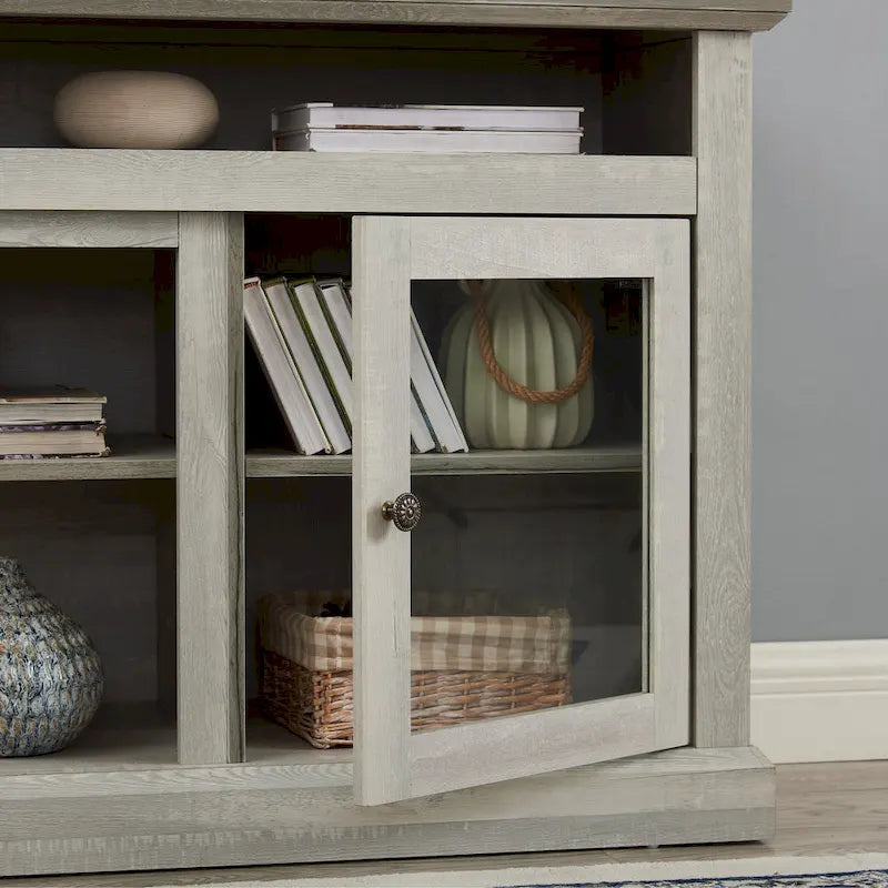 Meuble TV gris pierre 60 pouces avec gestion des câbles, portes vitrées et étagères réglables pour téléviseurs jusqu'à 65 pouces.